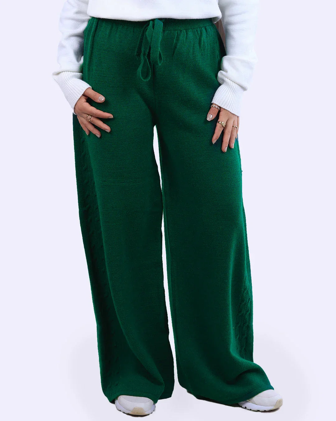Green knit wide-leg pants with drawstring waist, styled with a white sweater at WIND Shopping